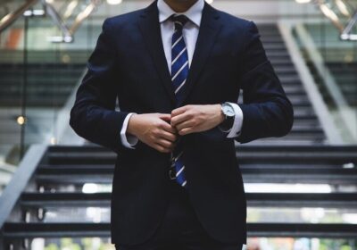 Blog Man in suit in front of staircase