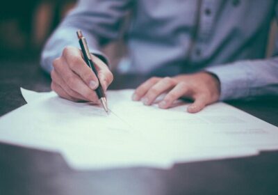 Blog Man signing legal papers